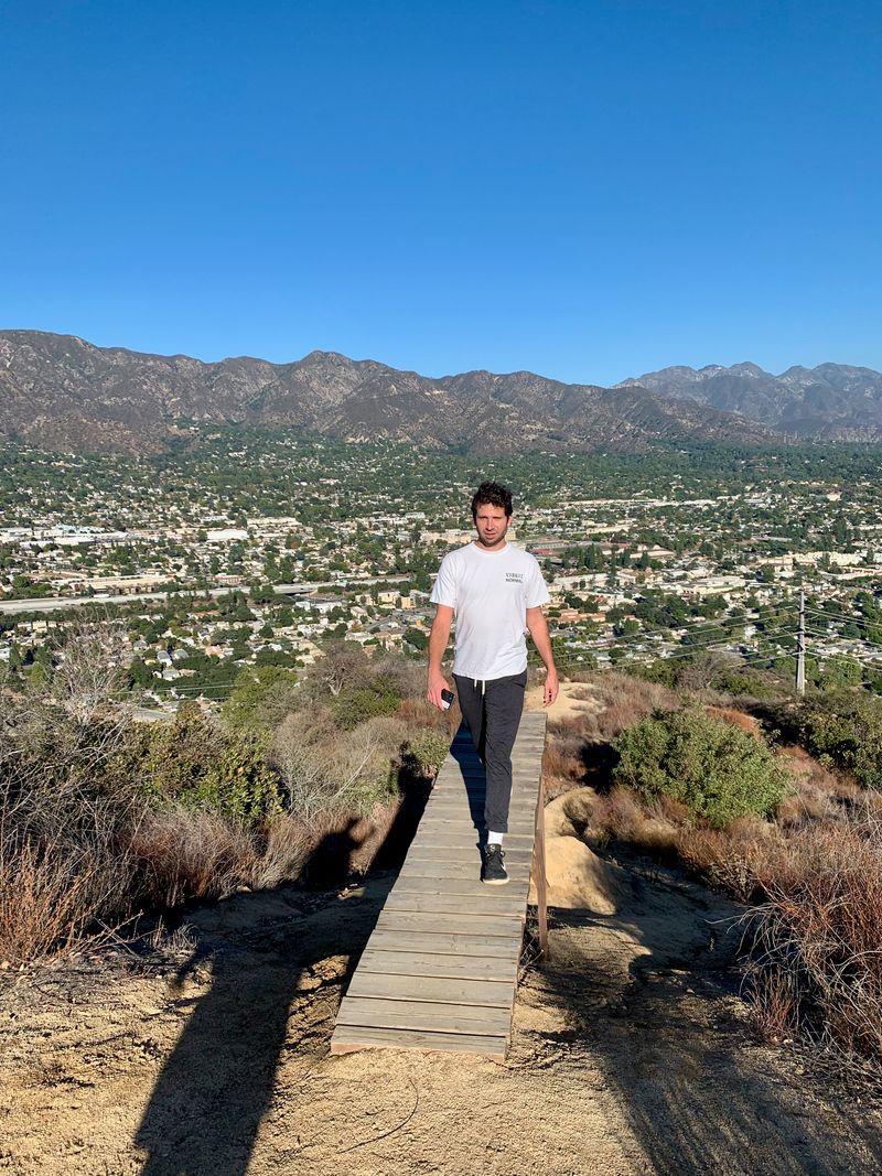 My sister's partner-of-significant-duration (my brother-in-vibe?) flaunting nothing on the way back from a rickety vantage overlooking a suburb of Los Angeles.