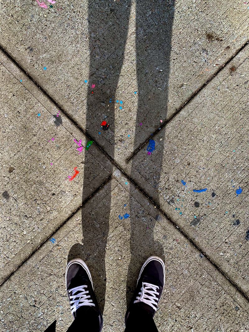 Shoegazing at an intersection in the sidewalk.