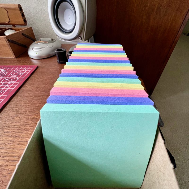 A mostly full box of Helsinki-themed Post-it® notes, like pastel steps to the gates of the mind.