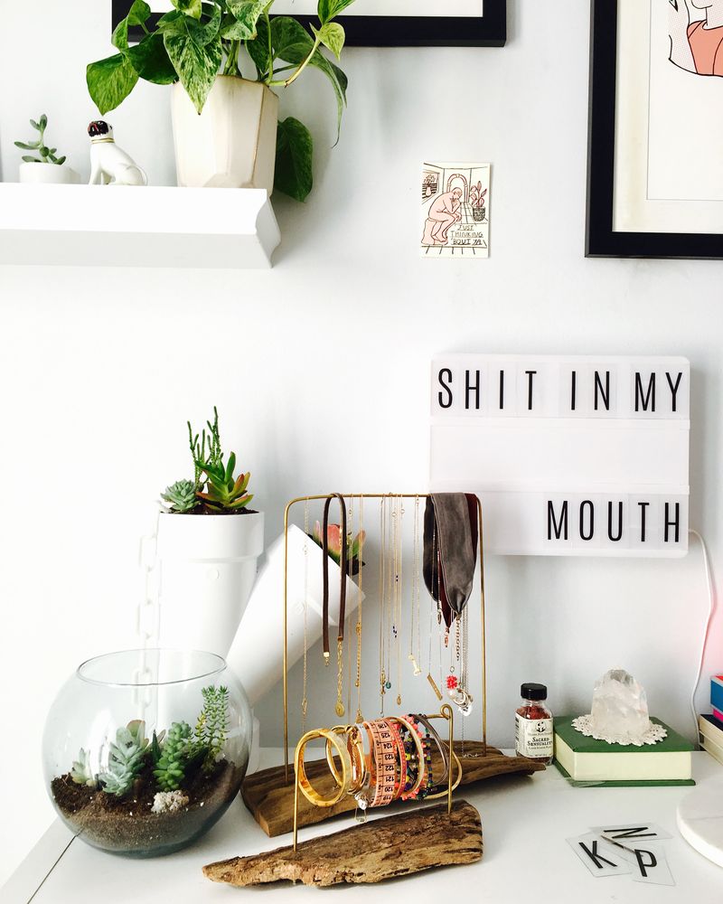 An Instagram®-worthy bedside table with 'SHIT IN MY MOUTH' lovingly expressed on the signboard.