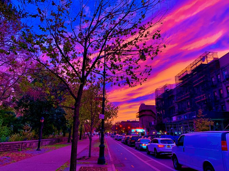 Purple night clouds hushing a busy street.