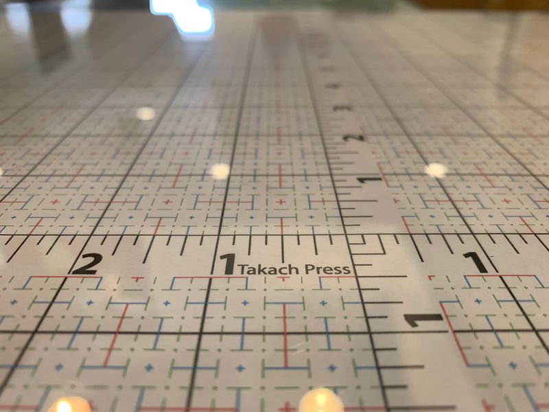 Close-up of an etching press registration grid, brought to you by Takach Press®.